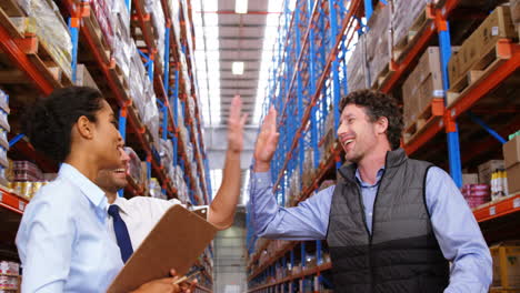 Warehouse-workers-speaking-together-