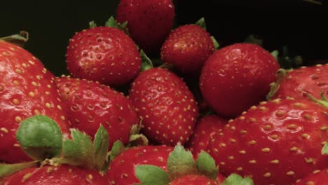 macro slide ripe juicy strawberry. healthy organic food. the camera moves through a heap of strawberries. dolly shot using a probe lens. red berries. close-up. type f.