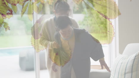 animation of asian grandmother and adult daughter sitting over leaves