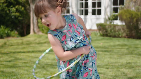 little girl playing with hula hoop toy happy child playing game having fun outdoors in sunny backyard garden enjoying childhood 4k