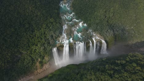 panoramic aerial establishing overview of braided turquoise streams of water leading to tamul waterfall