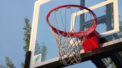 Persona-Que-Lanza-Una-Pelota-De-Baloncesto-En-Un-Aro-Nuevo-Y-Falla-La-Primera-Vez,-Luego-Hace-Un-Tiro-Fuera-Del-Tablero