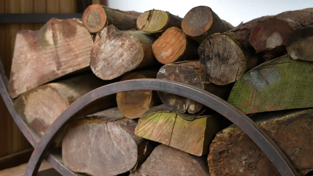firewood huddled in the woods next to the hut