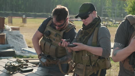 military men assembling weapons