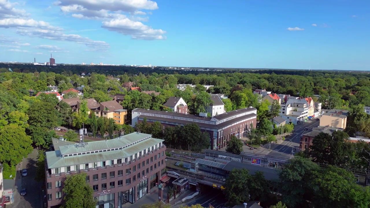 Předměstí Berlína Zehlendorf ukazující budovy a nádraží S-Bahn za slunečného letního dne. Nejlepší letecký pohled, rotace letu dronu doprava.