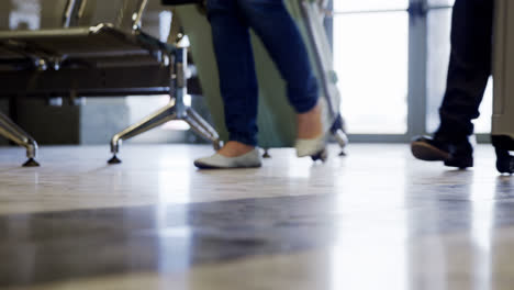 passengers walking with their luggage at airport