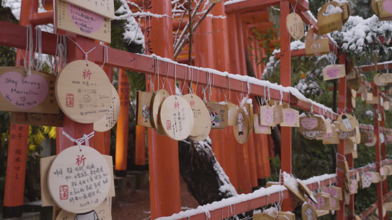 Wooden prayer boards, Ema, are hung up at a Japanese shrine, snowing, Kanazawa