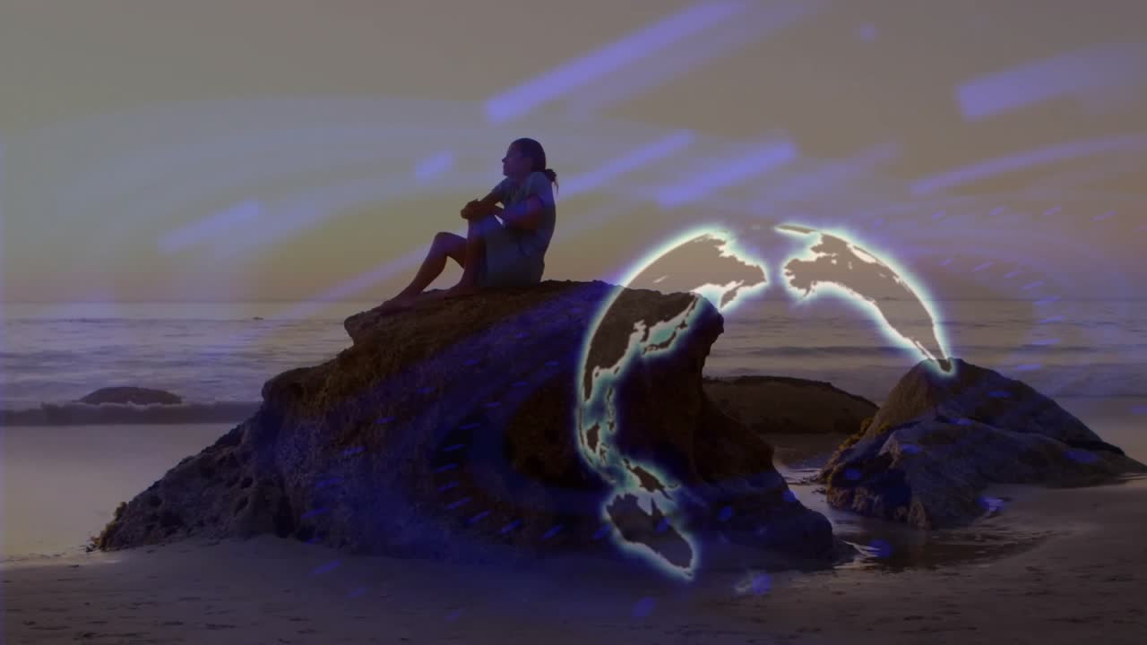 Donna che si avvicina a un masso sulla riva durante il tramonto, seduta in meditazione con un globo e scie luminose.