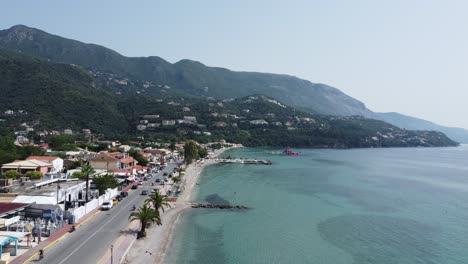 dolly in low altitude flight over ipsos beach in corfu, greece, showing clear, transparent blue waters