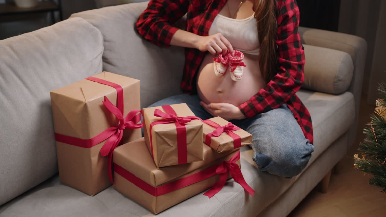 Pregnant woman with baby shoes