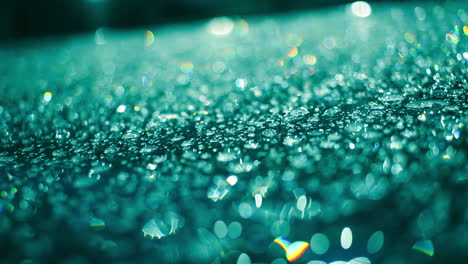 Rain-drops-on-glass-surface-in-aquamarine-color.-Macro-of-droplets-on-glass