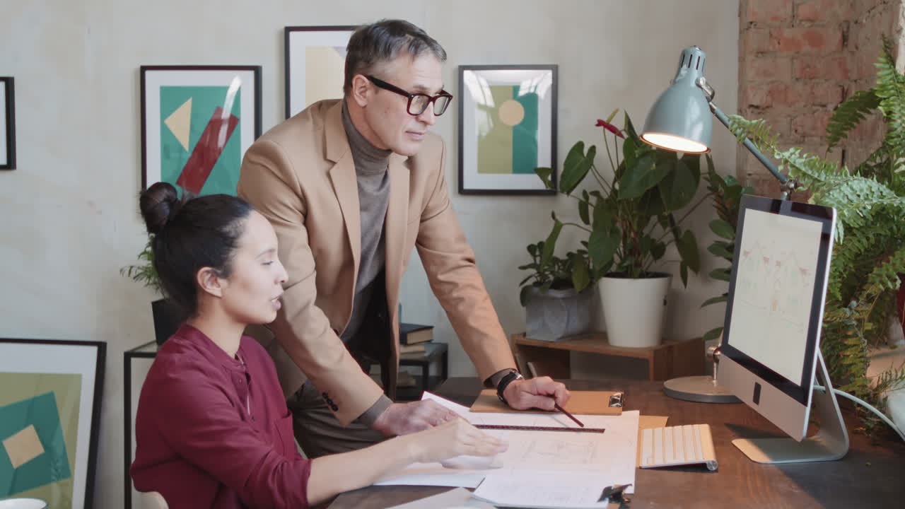 Two Architects Discussing Building Design On Computer