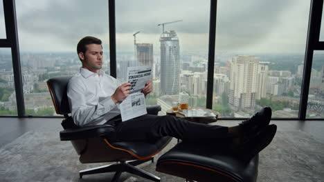 Businessman-resting-in-chair-with-newspaper.-Manager-reading-newspaper-in-office