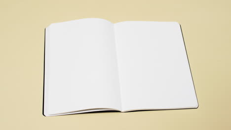 Video-of-book-with-white-blank-pages-and-copy-space-on-yellow-background