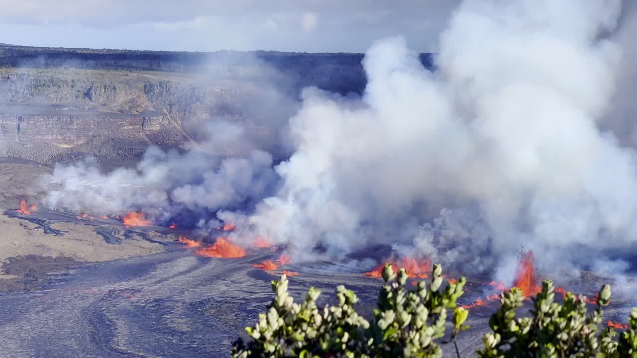 Cinematic long lens panning shot of the full caldera at Kilauea as the volcano erupts on the first day of activity in September 2023 at Hawai'i Volcanoes National Park