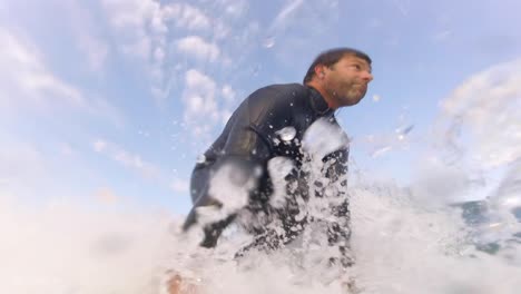 young man enjoying the surfing in waves