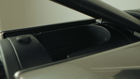 lid closing, partial view of a sleek, modern object being covered smoothly