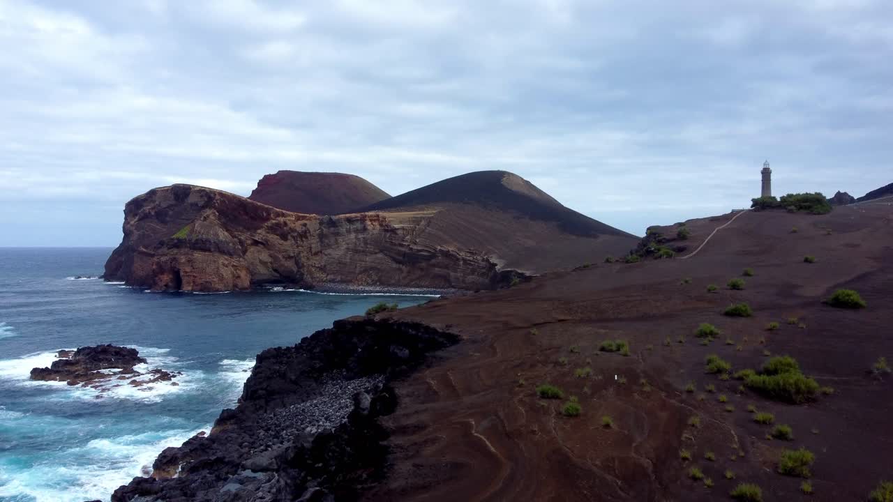 Spectacular drone footage over the Capelinhos Volcano in Faial, showcasing the dramatic volcanic landscape where land met sea during the 1957 eruption
