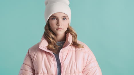 teenage caucasian girl with winter clothes in front of the camera.