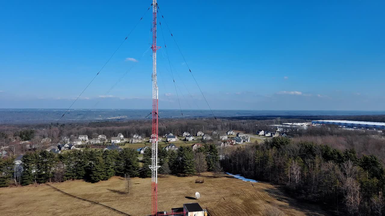 drone fly by radio tower on sunny day