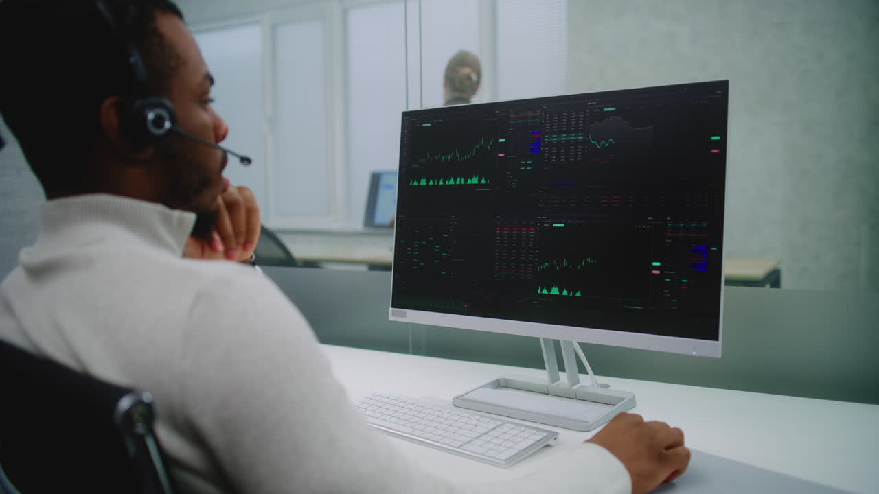 Businessman in Call Center Viewing Stock Market Data