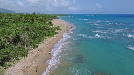 las olas se rompen en una playa de arena tropical en la república dominicana, antena estática