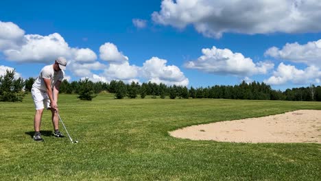 professional golf player prepare near sand bunker, scenic summer sky, latvia