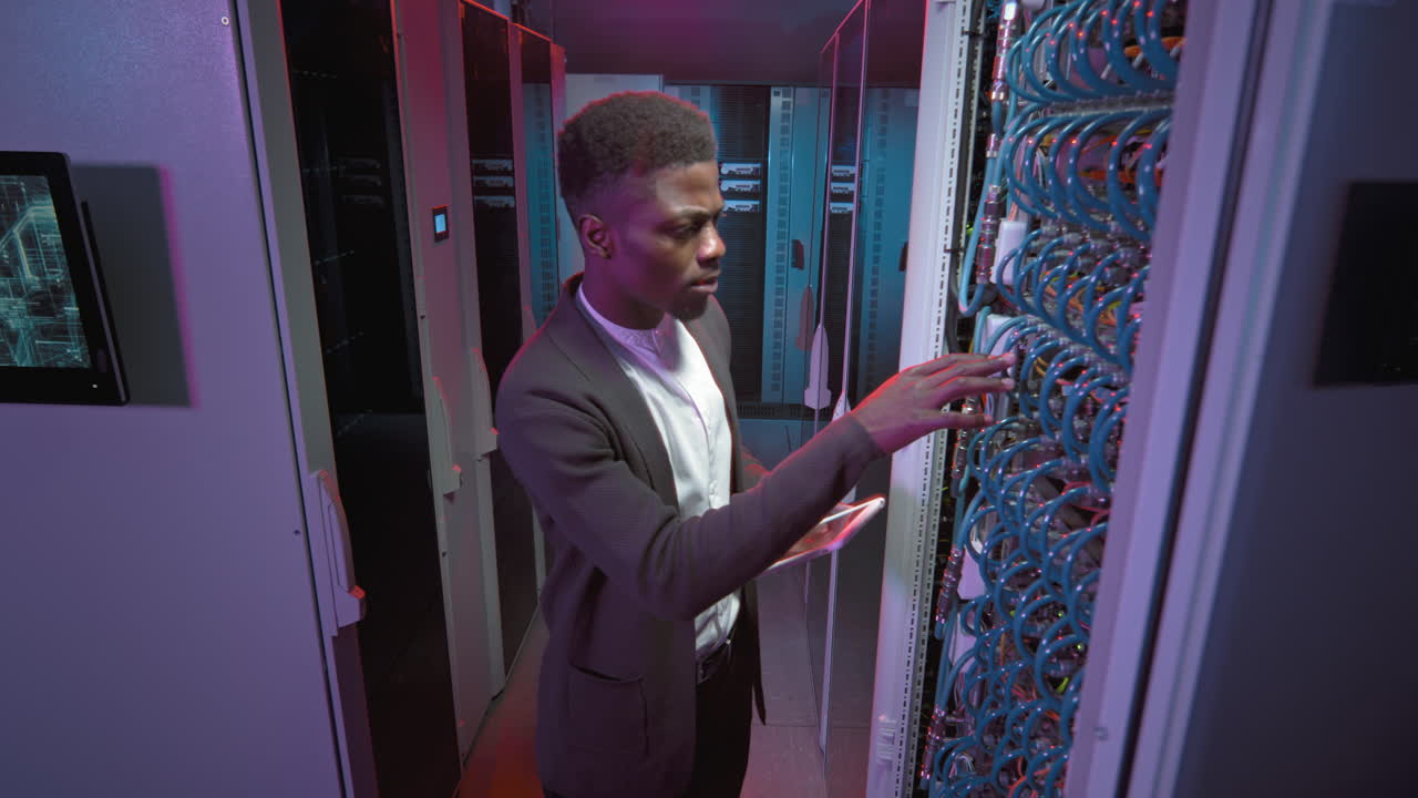 African-American Male Technician Working in Data Center