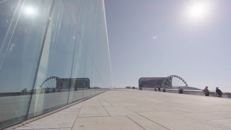 glazed modern exterior of oslo opera house in bjorvika port district, norway