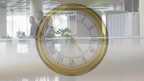 animation of moving clock over diverse colleagues talking in office