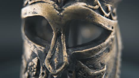 a close up macro detailed shot of a spartan face design, warrior ancient greek bronze helmet, on a 360 rotating stand, studio lighting, 4k smooth movement