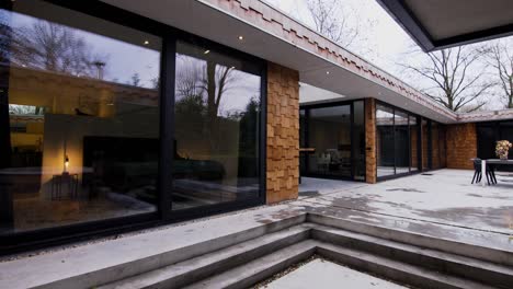 the outside of a modern vintage wooden house with hot tub