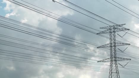 time lapse of clouds moving behind high tension wires and power lines