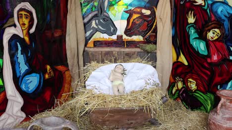 a beautiful handmade nativity with lights and figures of shepherds, joseph, jesus and mary. the baby jesus is amazing