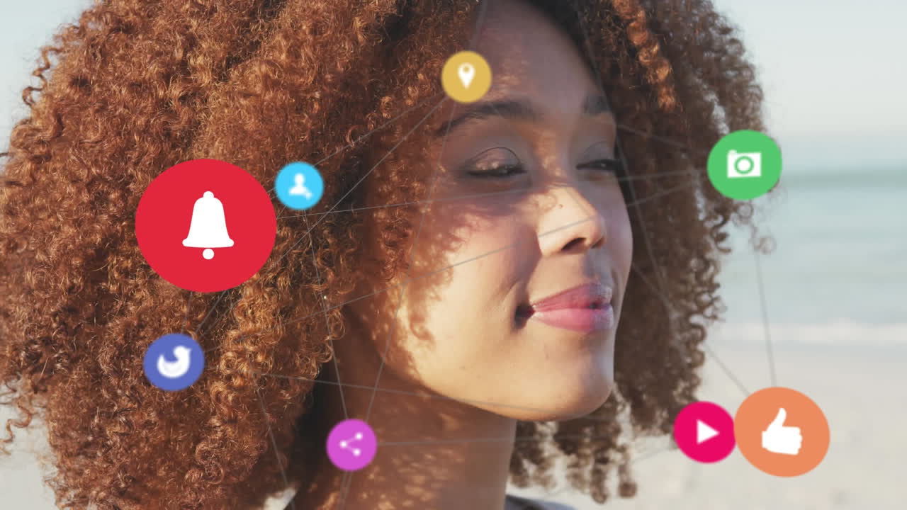 Animation of network of social media digital icons over smiling woman on beach