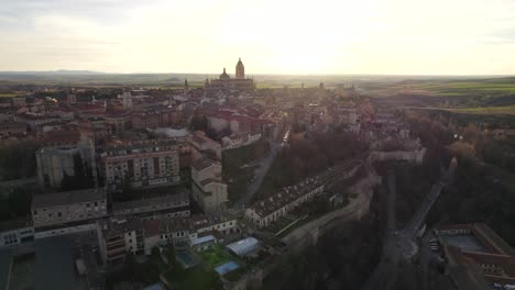 aerial ascent over spanish city of segovia at sunset time