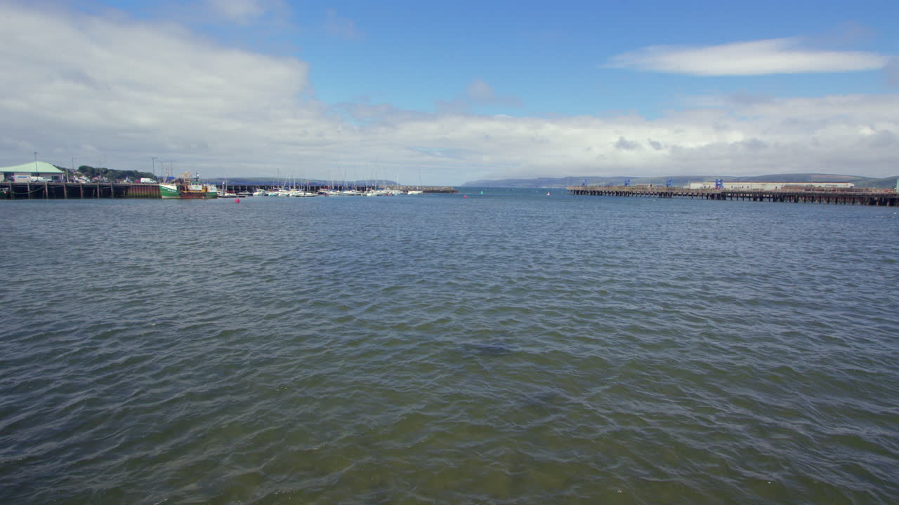 Wide shot of Stranraer Harbour and Marina with loch ryan in background