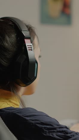 person with headphones playing video games