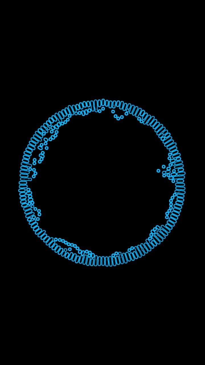 Dense blue spiral coil slinky ring with circular spring loops and loose particles on black background, vertical video asset
