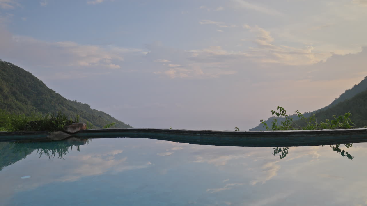 luxury swimming pool set in lush countryside of palm trees