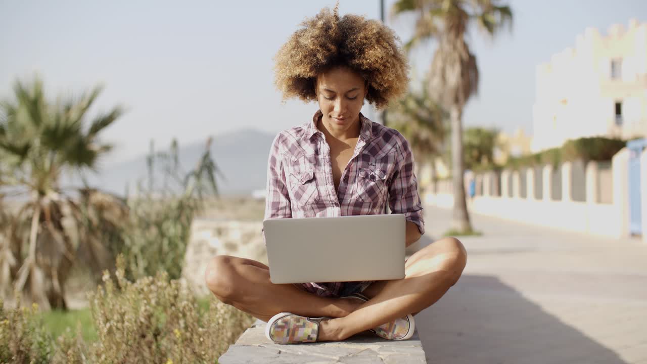 Girl Browsing A Laptop In A Bench