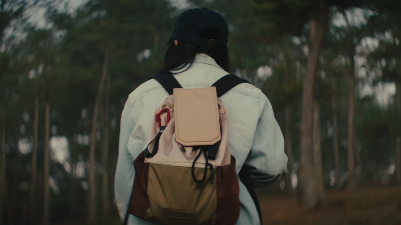 Woman Hiking in Forest with Backpack