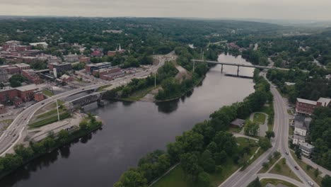 river magog flowing through sherbrooke city in canada - aerial drone shot