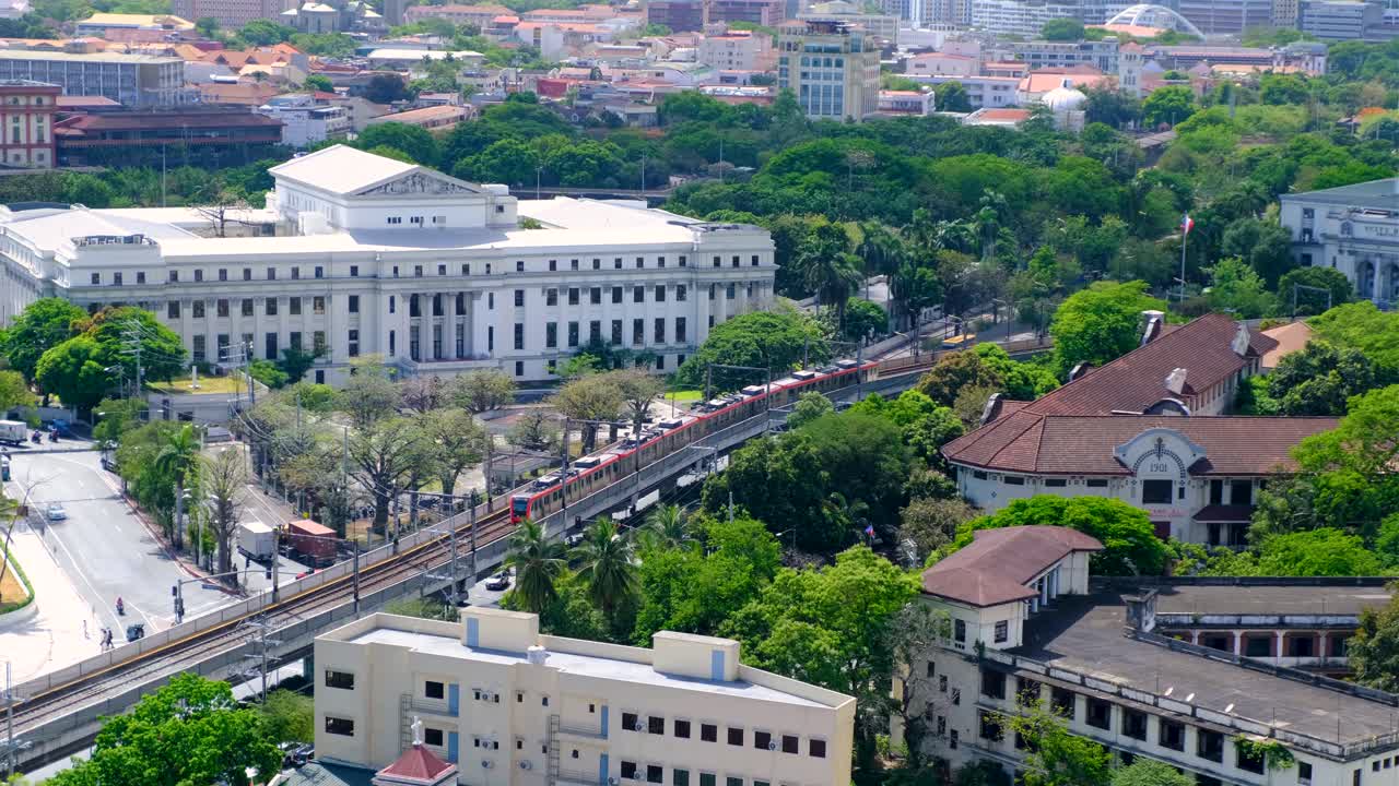 Aerial view of train passing the National Museum of Fine Arts in capital city metropolis of Manila, Philippines