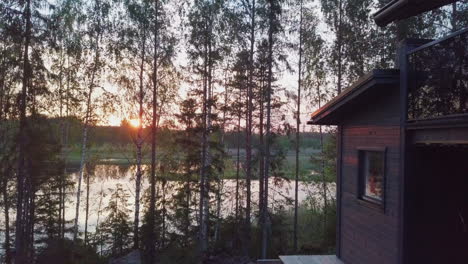 dolly view nordic summer cabin and sunset over lake, nordic vacation scene