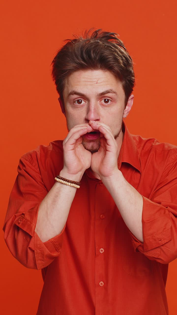 Caucasian man whisper news rumors holding hands near mouth share gossip quiet keep my secrets