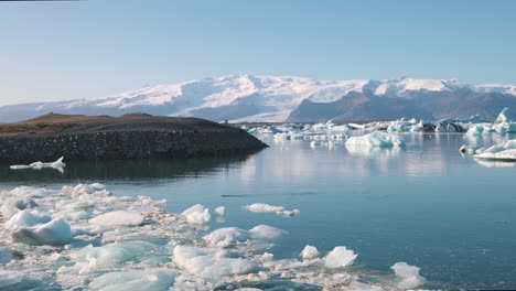 arctic sea lagoon panorama in iceland with icebergs and mountains