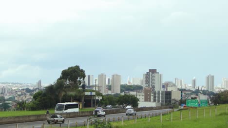 Daily-traffic-in-a-road-at-Franca,-country-side-city-with-many-buildings-at-back