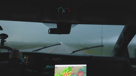 passenger view of storm chasers driving in heavy rain slow motion