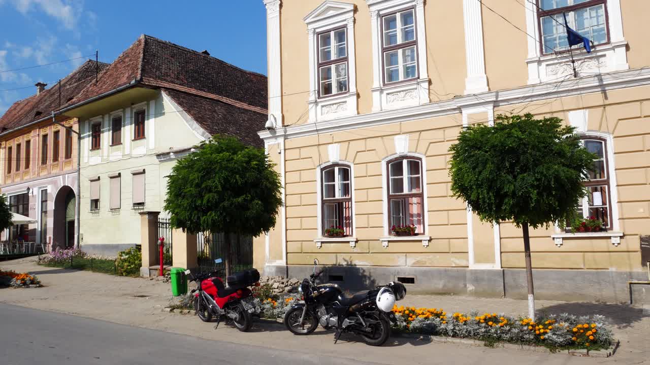 Panning shot of the main street of Biertan, Romania. The village host a fortified church which is an Unesco World Heritage location.